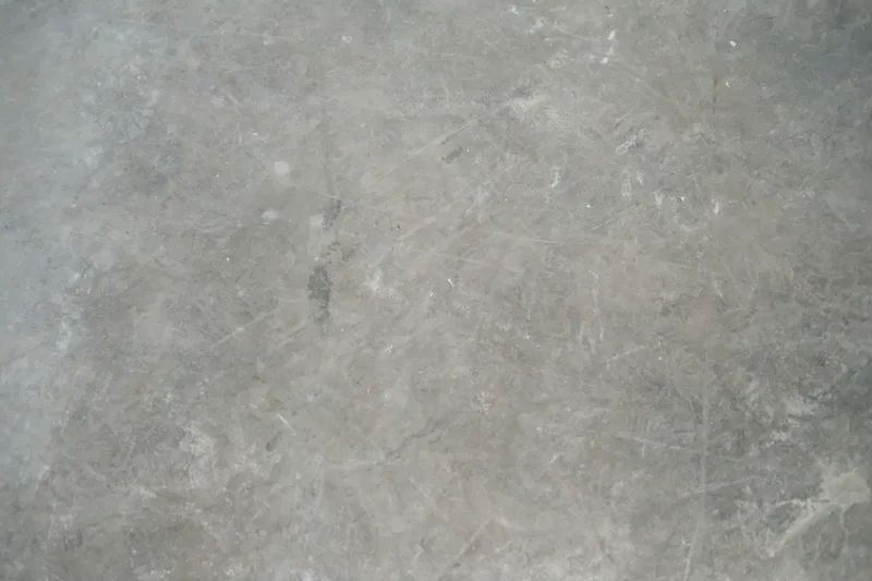 Cracked, stained concrete laundry floor before epoxy coating in Guildford